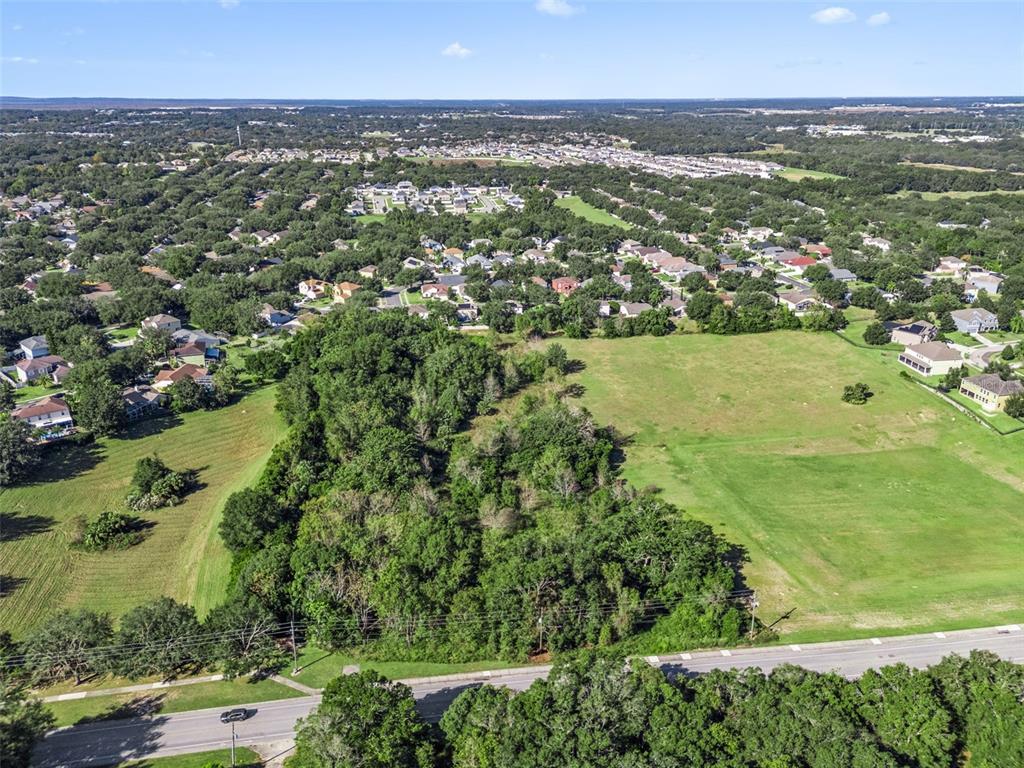 2228 Vick Road Apopka, FL 32712 - Photo 21 of 26 an aerial view of residential houses with outdoor space and trees
