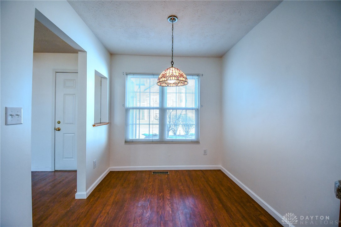 3915 East Summit Ridge Drive Beavercreek, OH 45430 - Photo 15 of 47 This dining area features rich wood flooring and a charming light fixture, ready for your personal touch.