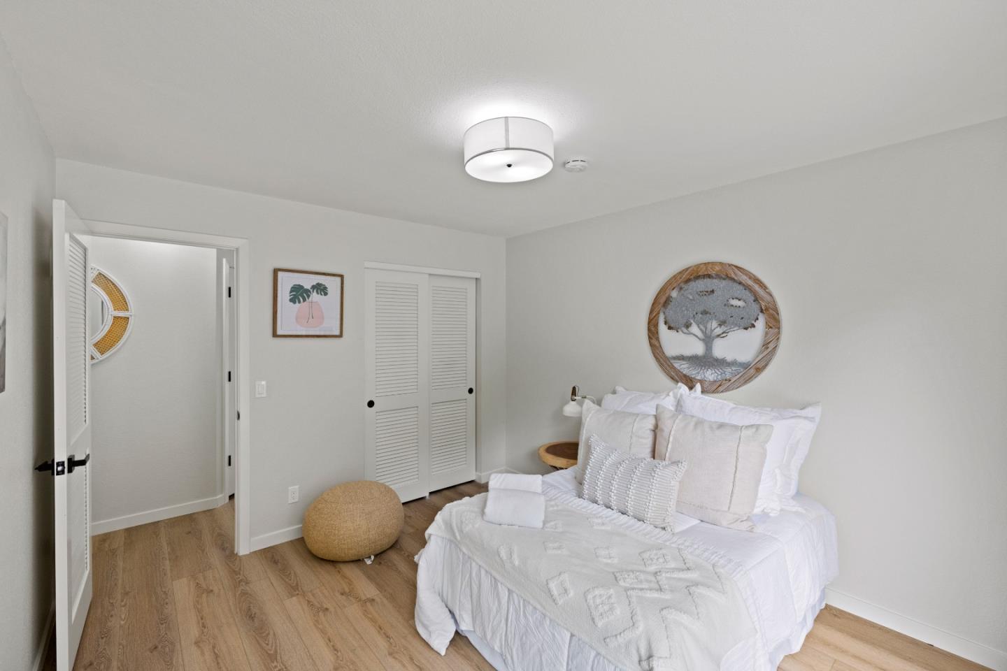3465 Rio Road Carmel, CA 93923 - Photo 19 of 28 a bedroom with a bed and a chandelier