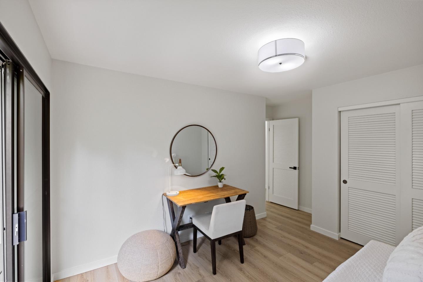 3465 Rio Road Carmel, CA 93923 - Photo 23 of 28 a room with wooden floor and white walls