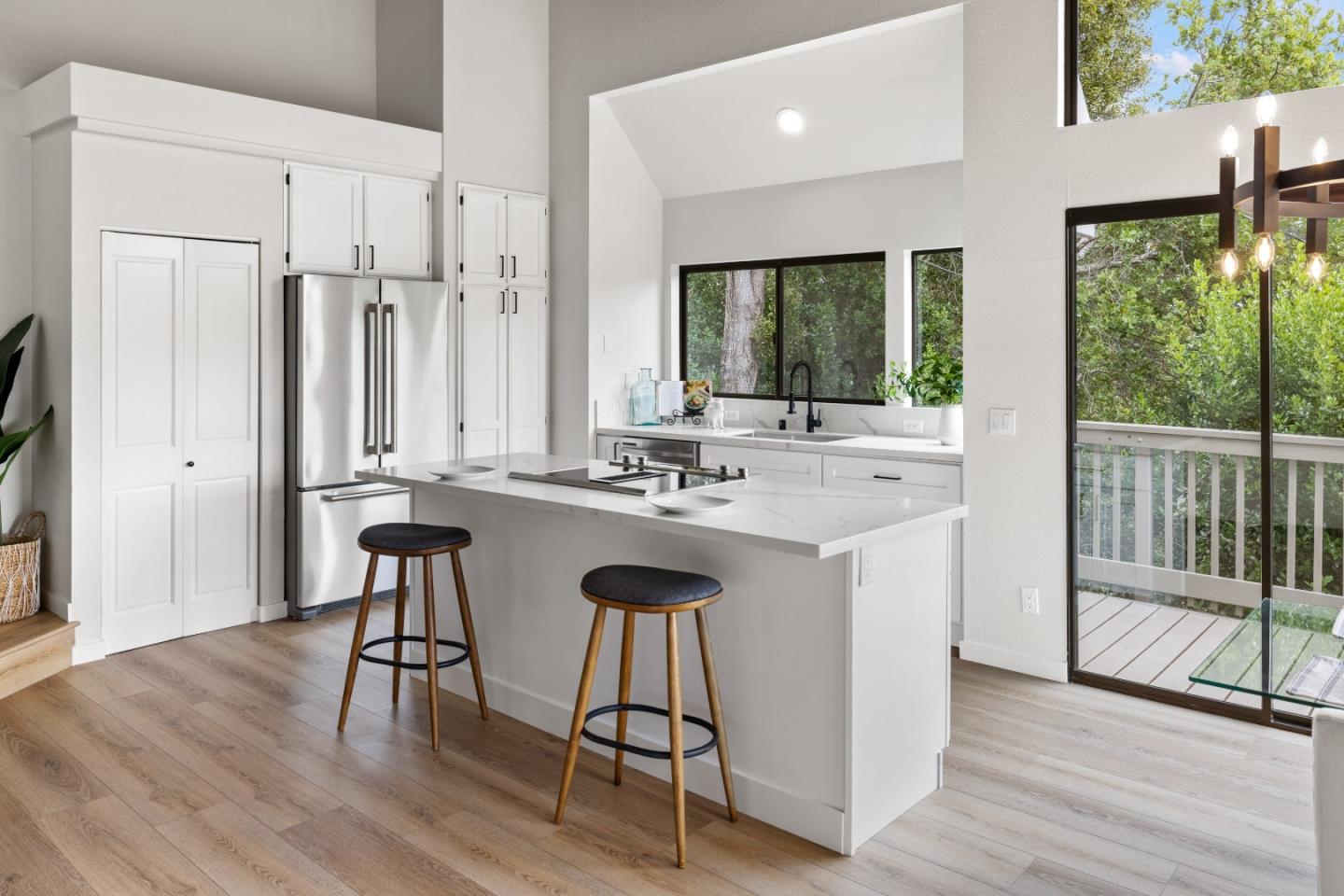 3465 Rio Road Carmel, CA 93923 - Photo 5 of 28 a kitchen with stainless steel appliances granite countertop a stove a sink and a refrigerator with wooden floor