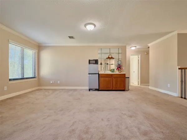 a view of a livingroom with furniture and a window