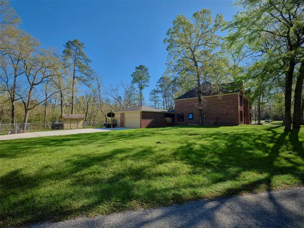 a view of a house with a backyard