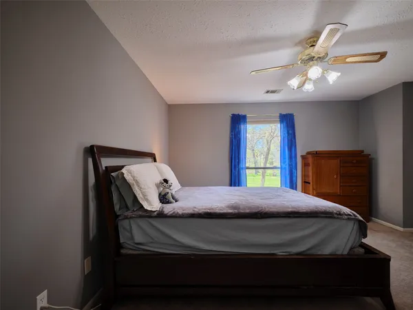 a bedroom with furniture and a baby crib