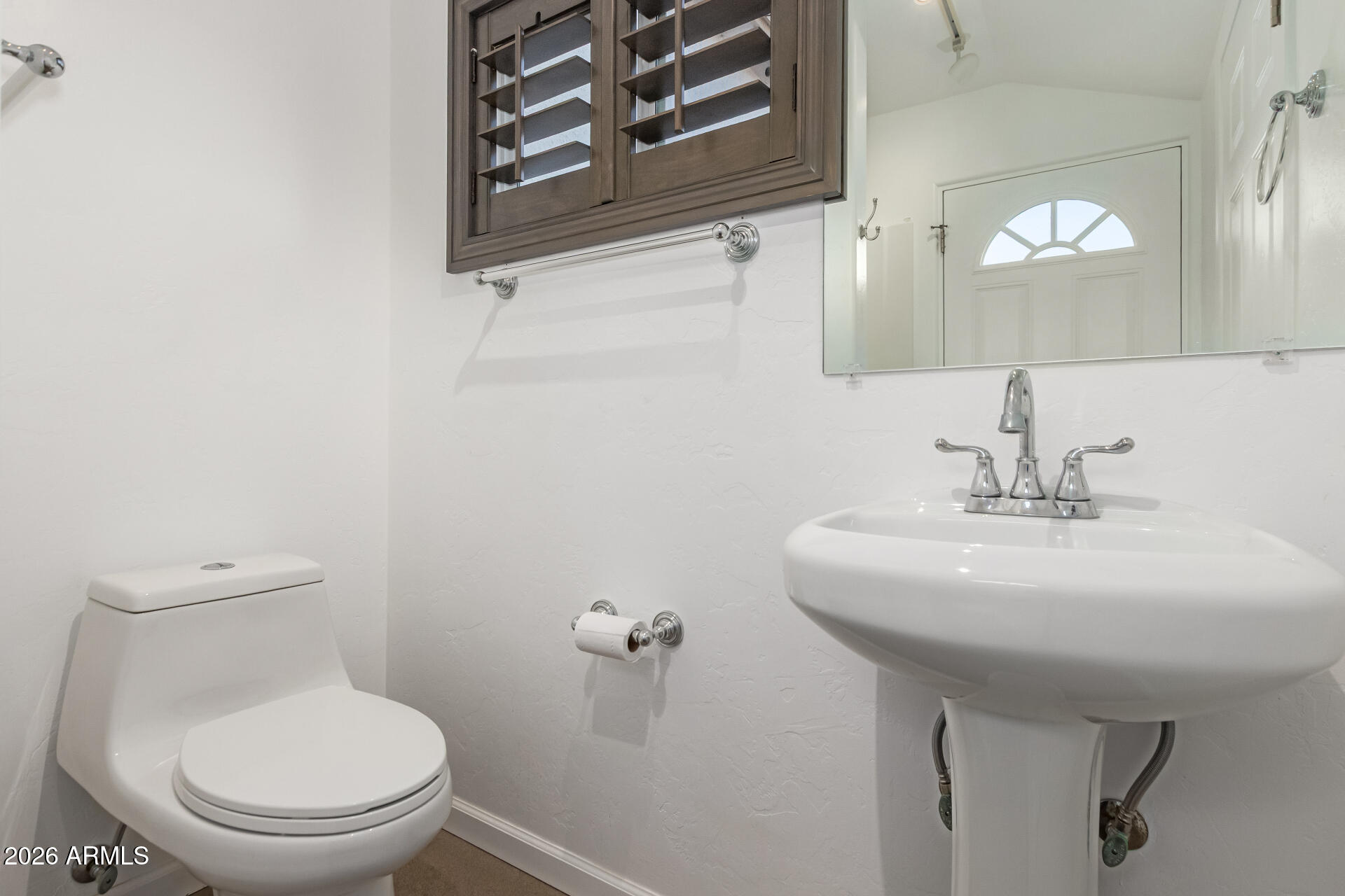 373 Camino A Las Casitas Rio Rico, AZ 85648 - Photo 38 of 40 a bathroom with a toilet a sink and mirror