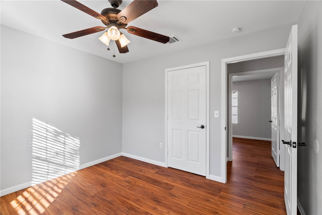 804 Ave B Street Sinton, TX 78387 - Photo 16 of 40 wooden floor in an empty room with a window