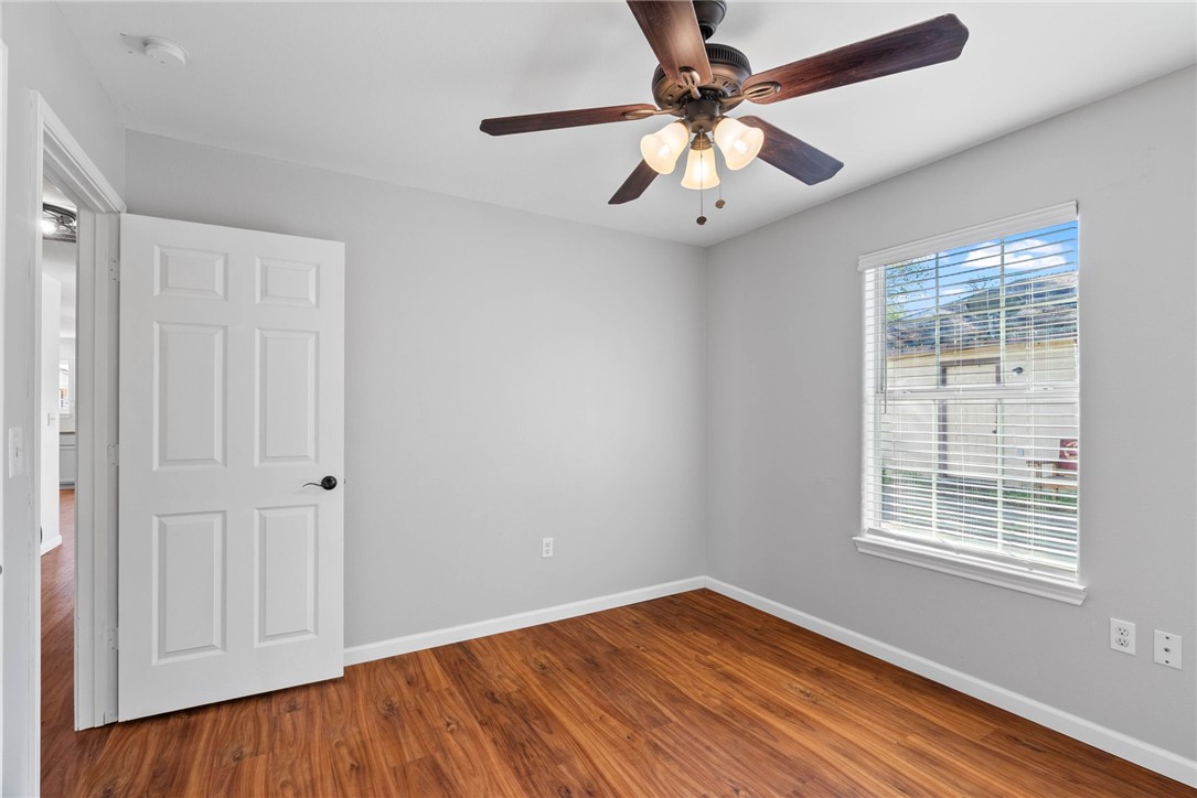 804 Ave B Street Sinton, TX 78387 - Photo 18 of 40 wooden floor in an empty room with a window