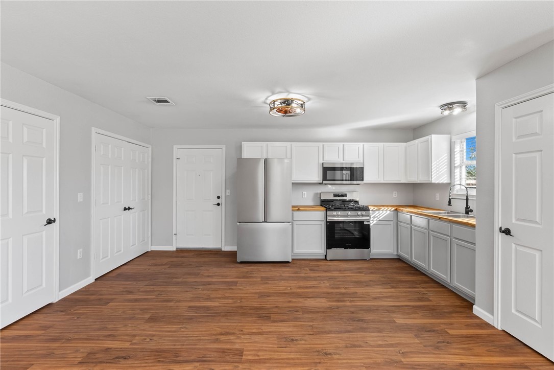 804 Ave B Street Sinton, TX 78387 - Photo 3 of 40 a kitchen with granite countertop a stove top oven and cabinets