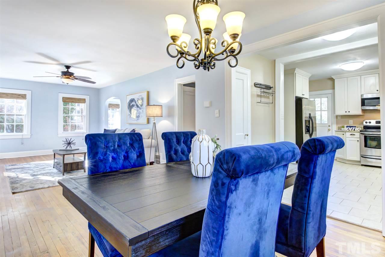 413 Dixie Trail Raleigh, NC 27607 - Photo 14 of 30 a living room with furniture a chandelier and a wooden floor