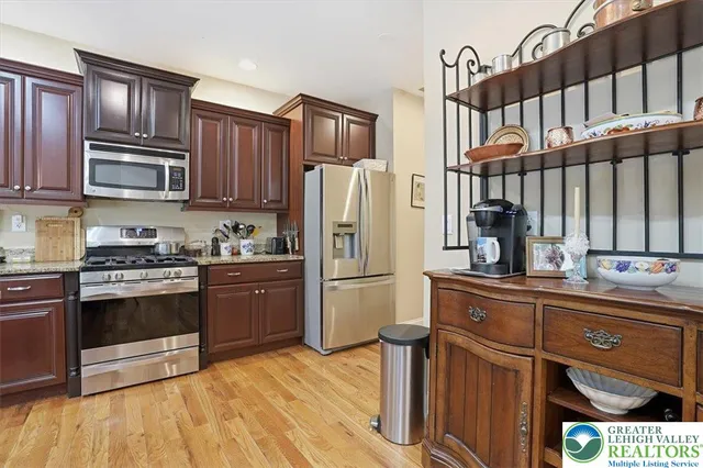 a bathroom with a granite countertop sink a mirror and vanity