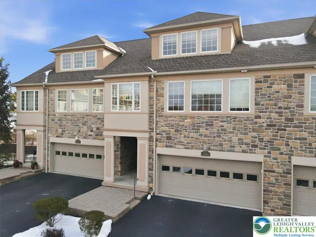 a view of a hallway with a wooden floor and a large window