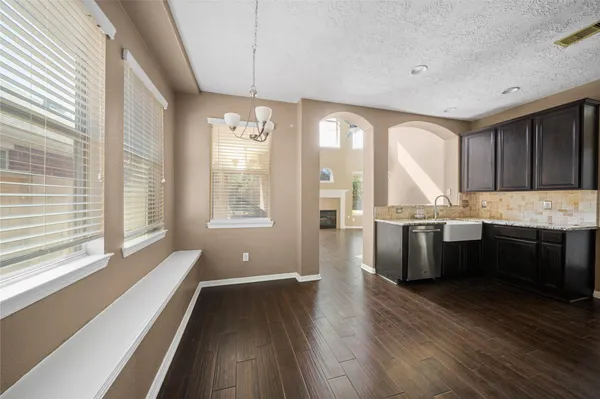 a kitchen with stainless steel appliances granite countertop a stove a sink and a large refrigerator