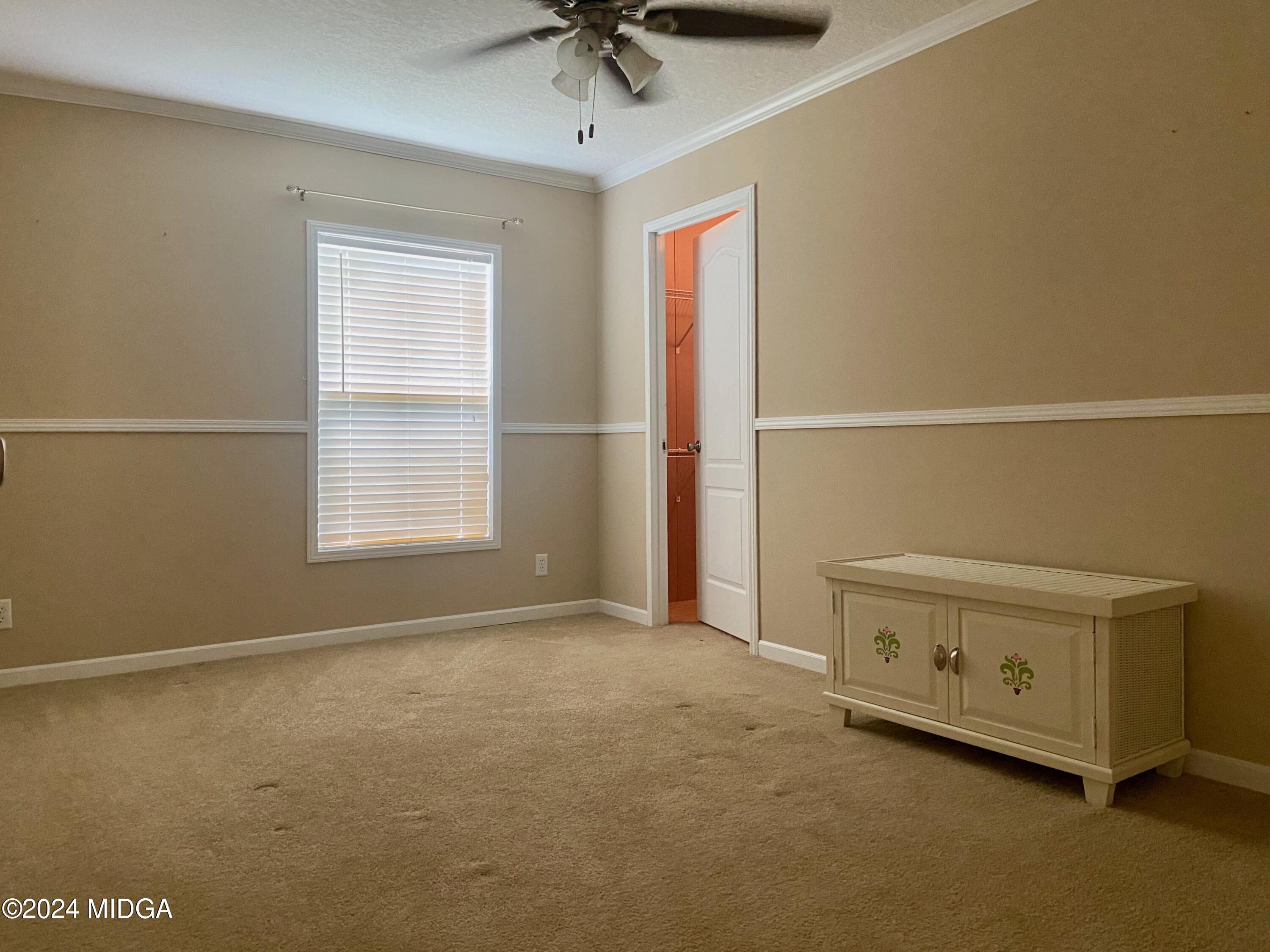 1179 Union Church Road Fort Valley, GA 31030 - Photo 17 of 20 an empty room with a window and a ceiling fan