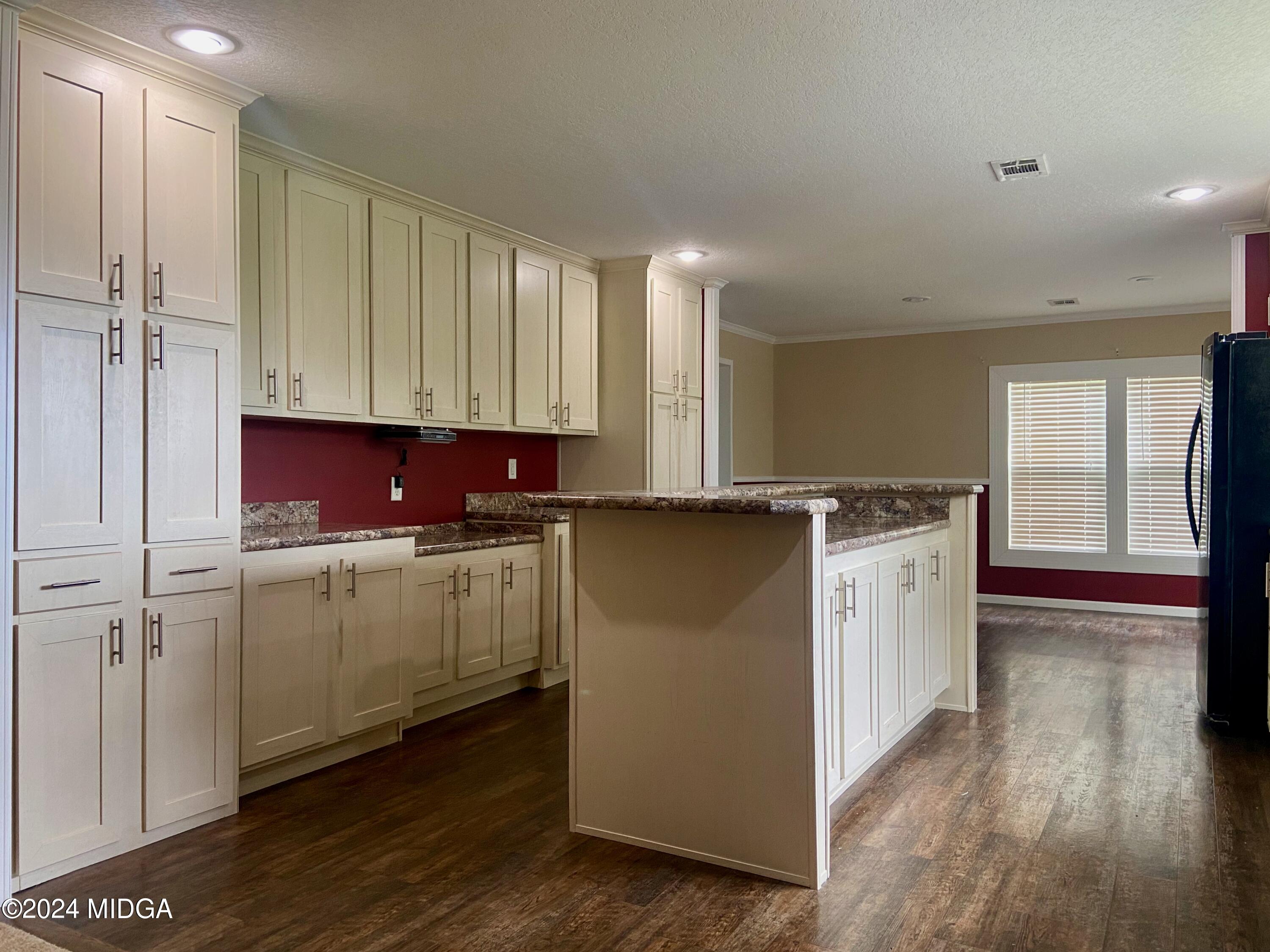 1179 Union Church Road Fort Valley, GA 31030 - Photo 8 of 20 a kitchen with cabinets and wooden floor