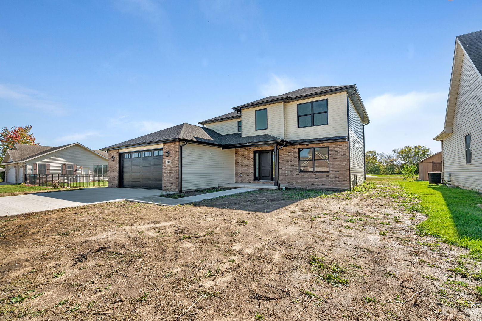 a front view of a house with a yard and garage