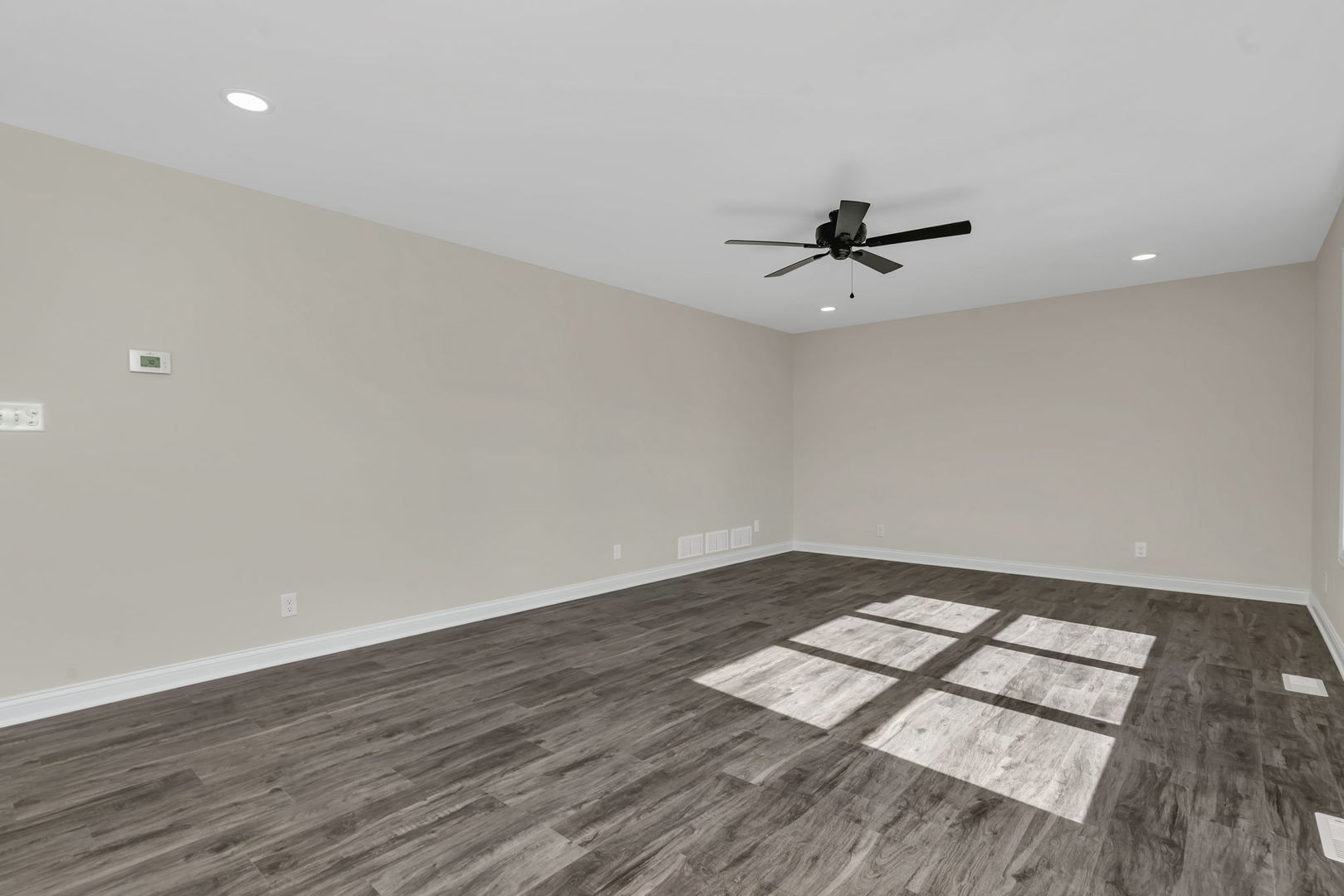 903 Springhill Drive Coal City, IL 60416 - Photo 12 of 37 an empty room with wooden floor and ceiling fan