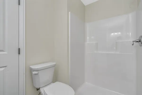 a white toilet sitting next to a bath tub