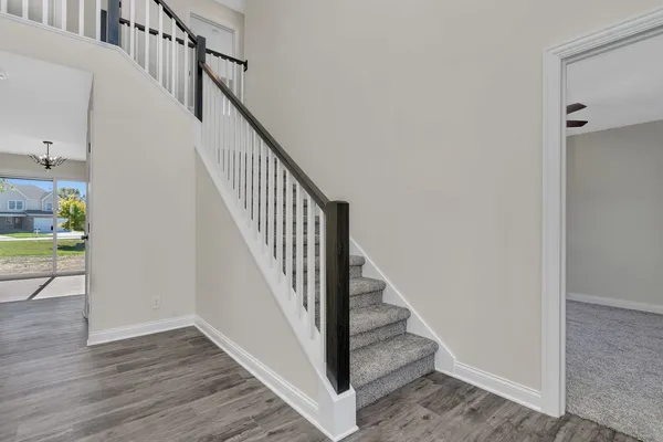 a view of entryway and hall with wooden floor