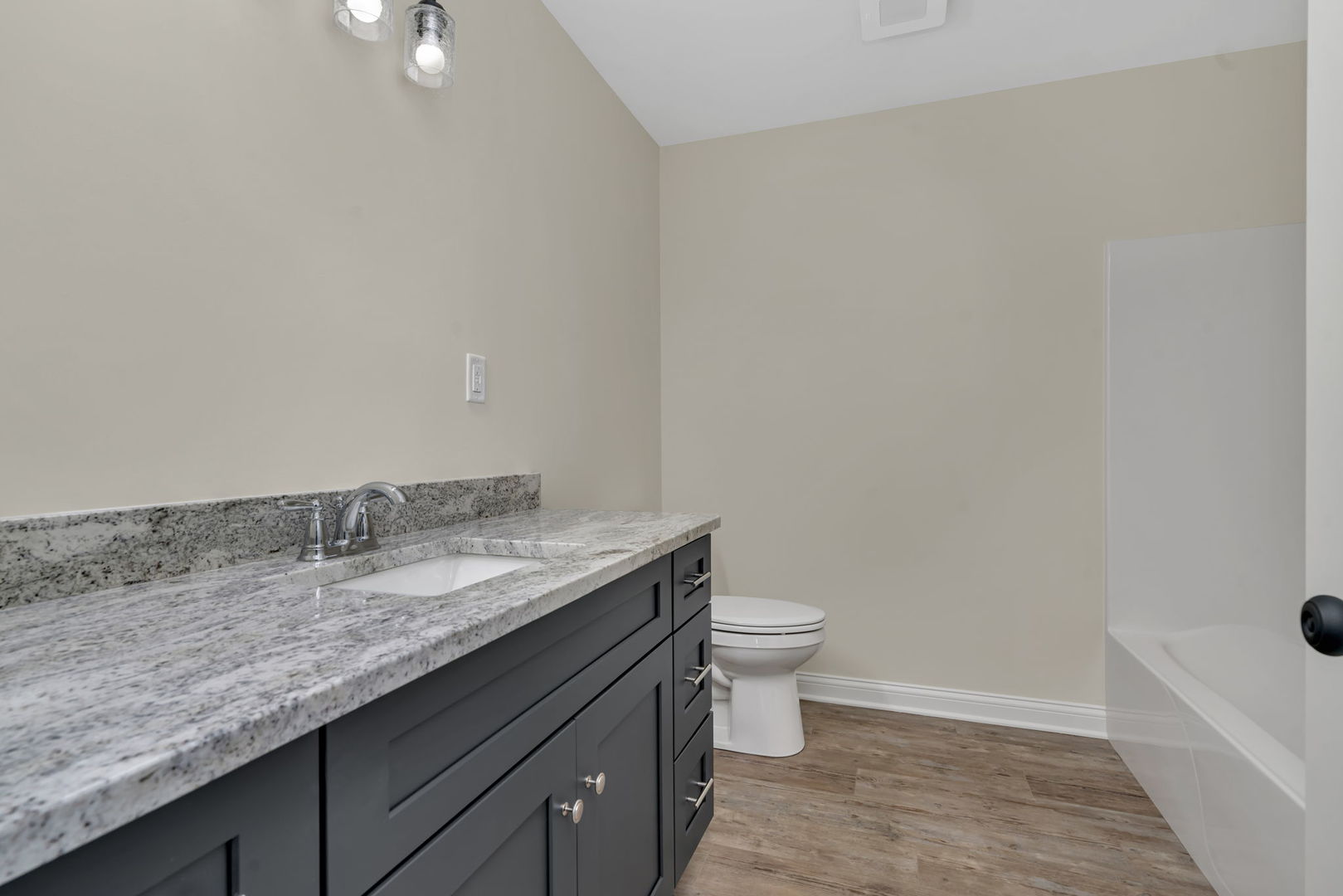 903 Springhill Drive Coal City, IL 60416 - Photo 22 of 37 a bathroom with a granite countertop sink a toilet and bathtub