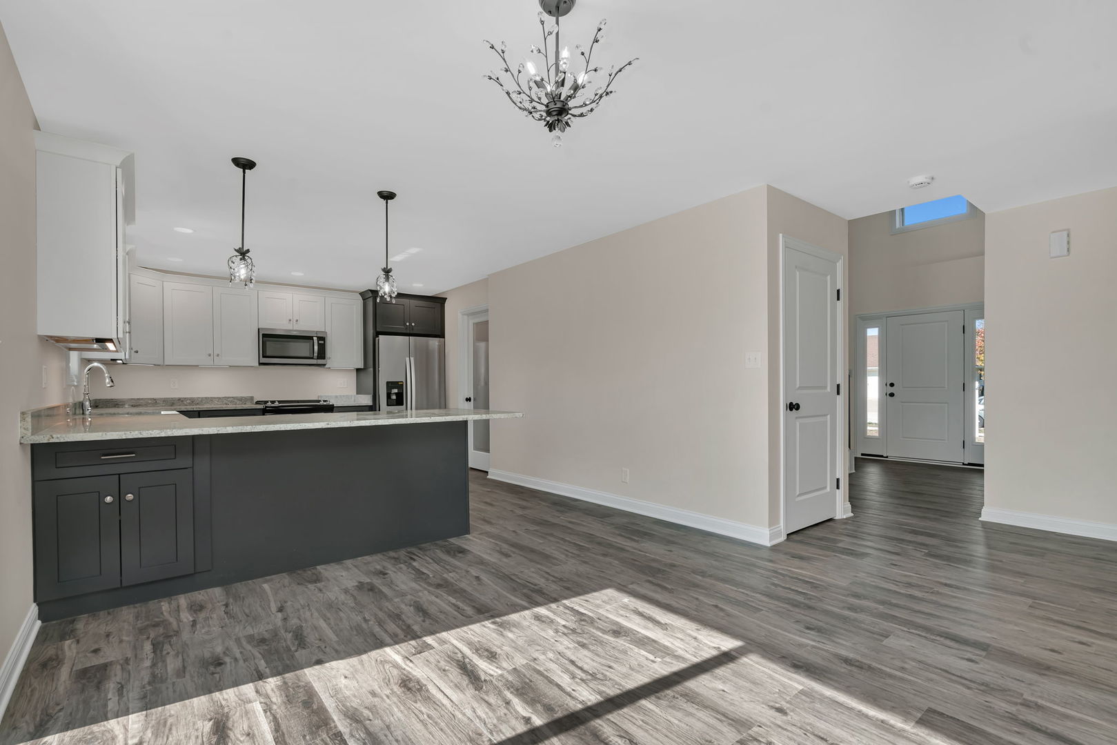 903 Springhill Drive Coal City, IL 60416 - Photo 5 of 37 a kitchen with stainless steel appliances granite countertop a refrigerator a sink dishwasher a stove and white cabinets with wooden floor