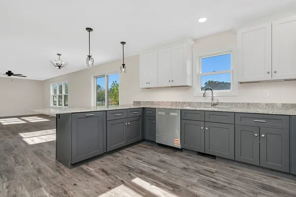 a kitchen with stainless steel appliances granite countertop a sink a stove and cabinets