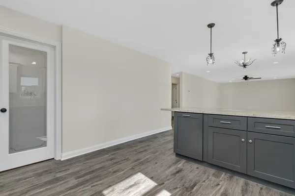 a view of an empty room and wooden floor