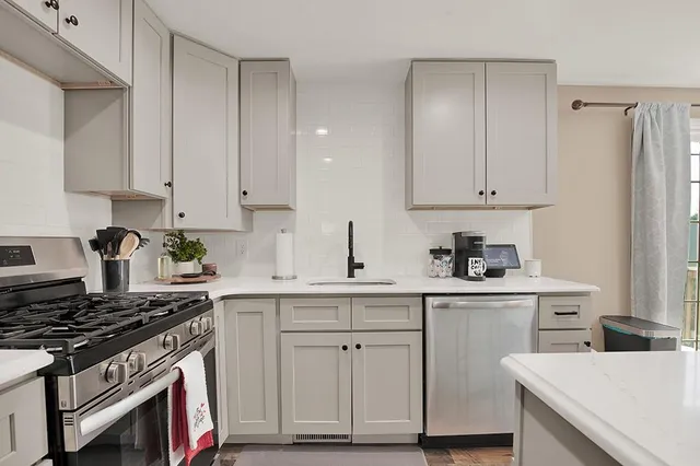 a kitchen with cabinets and appliances
