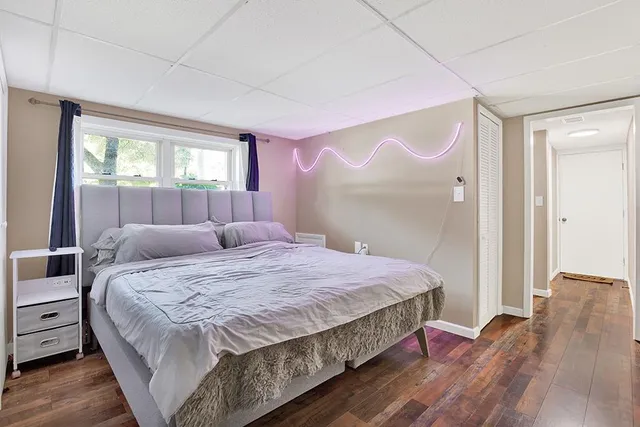 a bedroom with a bed and a mirror