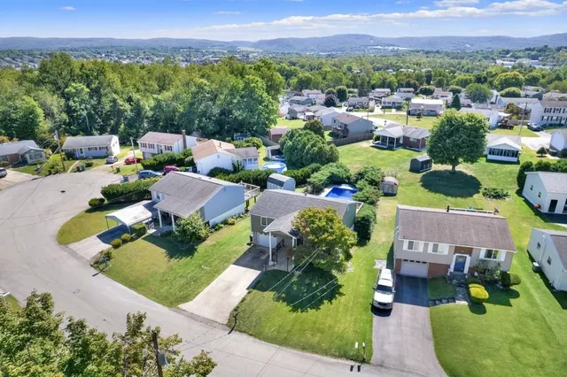 an aerial view of a house with yard swimming pool and outdoor seating