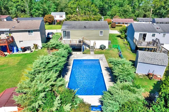 an aerial view of a house with a yard