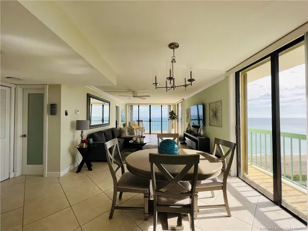 a living room with furniture and a floor to ceiling window