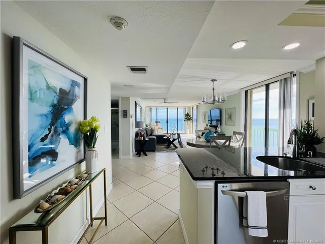 a kitchen with white cabinets and sink