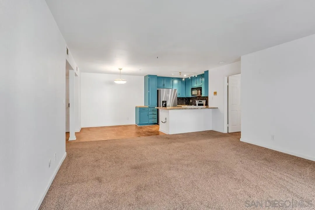 5745 Friars Road, Unit 104 San Diego, CA 92110 - Photo 13 of 37 a view of a kitchen with a refrigerator a kitchen and a sink