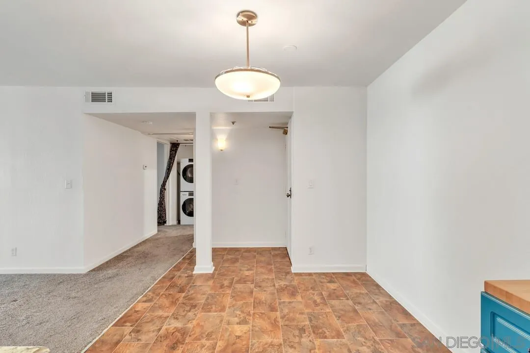 5745 Friars Road, Unit 104 San Diego, CA 92110 - Photo 18 of 38 a view of a hallway with a chandelier