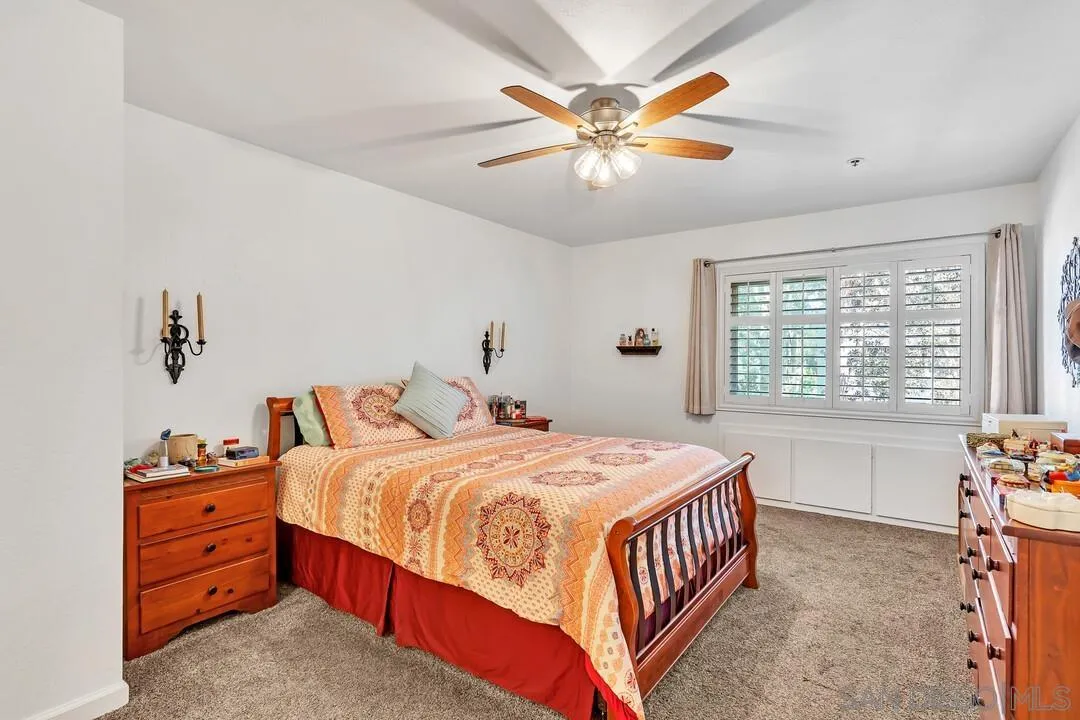 5745 Friars Road, Unit 104 San Diego, CA 92110 - Photo 19 of 38 a bedroom with a bed and a chandelier