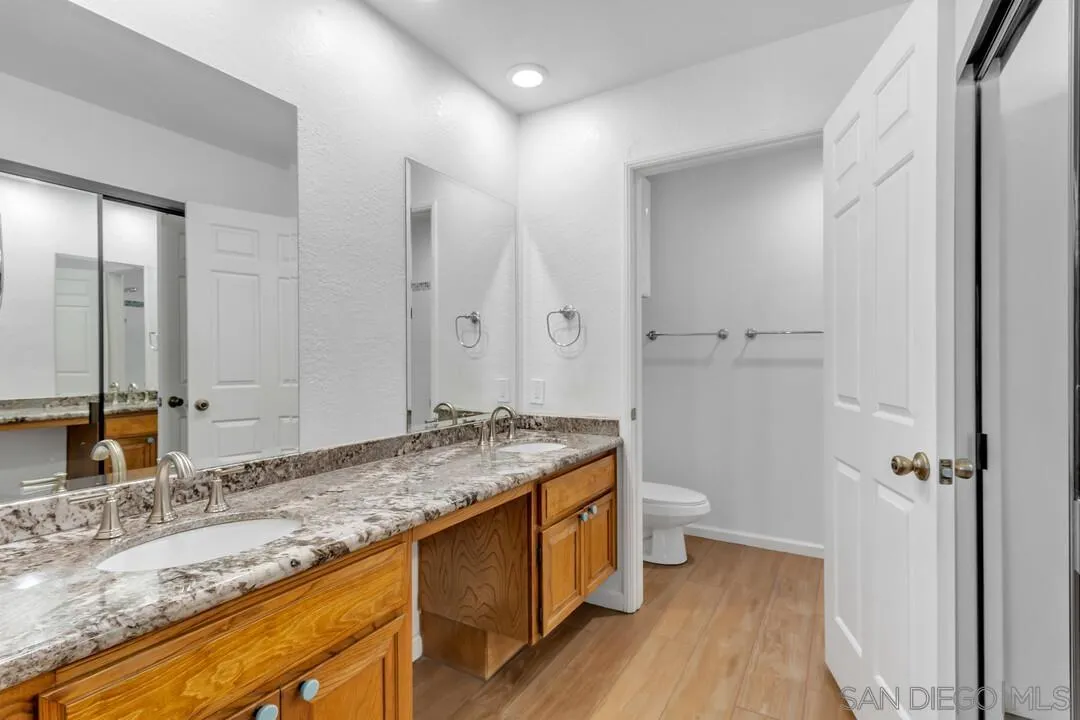 5745 Friars Road, Unit 104 San Diego, CA 92110 - Photo 25 of 37 a bathroom with a granite countertop sink toilet and shower