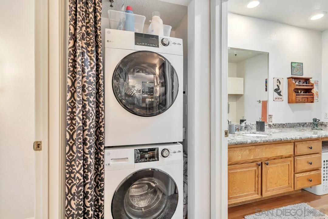 5745 Friars Road, Unit 104 San Diego, CA 92110 - Photo 25 of 38 a view of a bedroom with washer and dryer