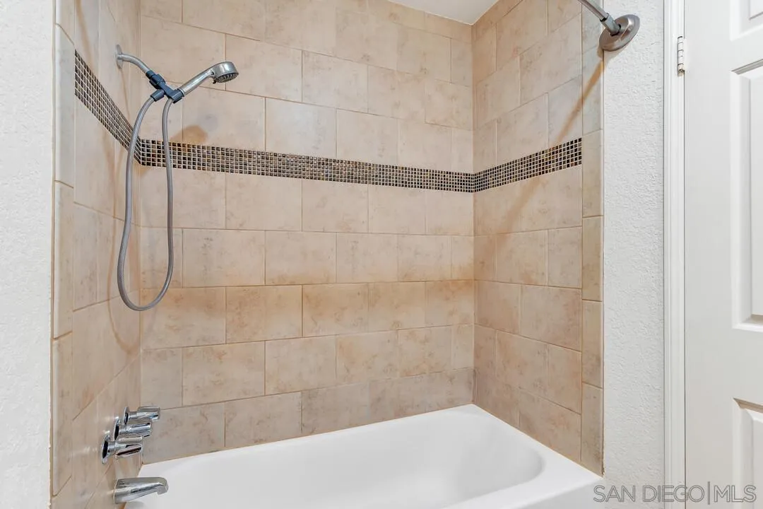 5745 Friars Road, Unit 104 San Diego, CA 92110 - Photo 27 of 38 a bathroom with a shower and a shower head