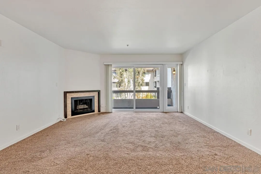 5745 Friars Road, Unit 104 San Diego, CA 92110 - Photo 6 of 37 a view of an empty room with a fireplace and a window