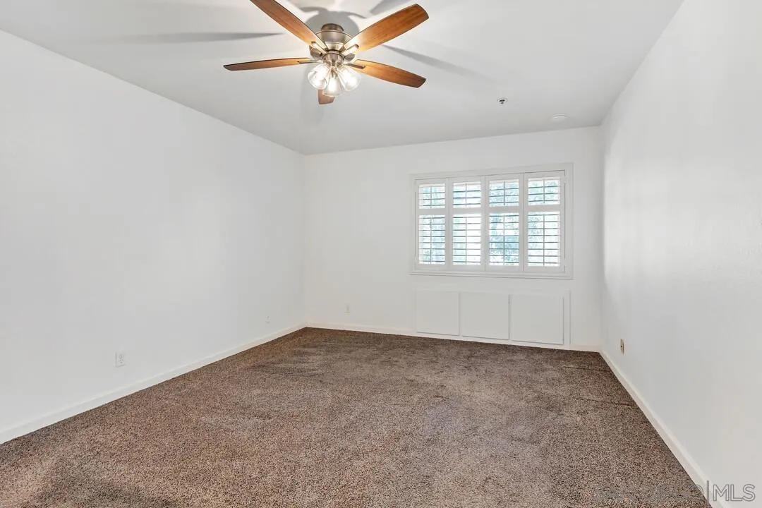 5745 Friars Road, Unit 104 San Diego, CA 92110 - Photo 9 of 38 an empty room with windows and fan