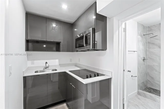 a utility room with cabinets washer and dryer