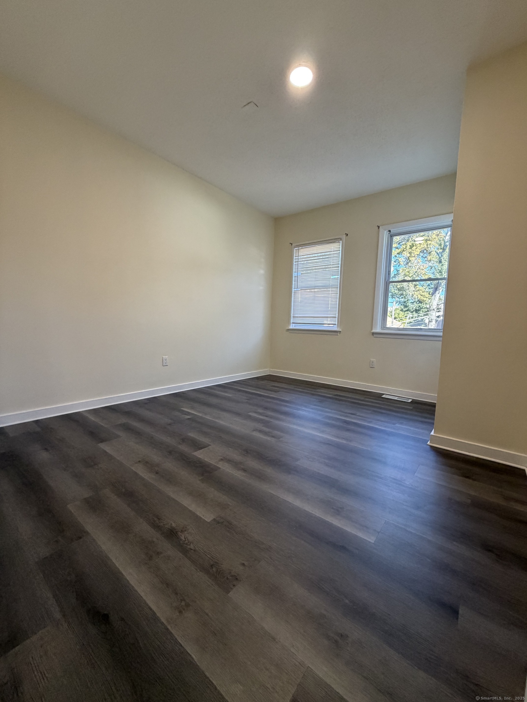 13 Lines Street New Haven, CT 06519 - Photo 11 of 12 an empty room with wooden floor and windows