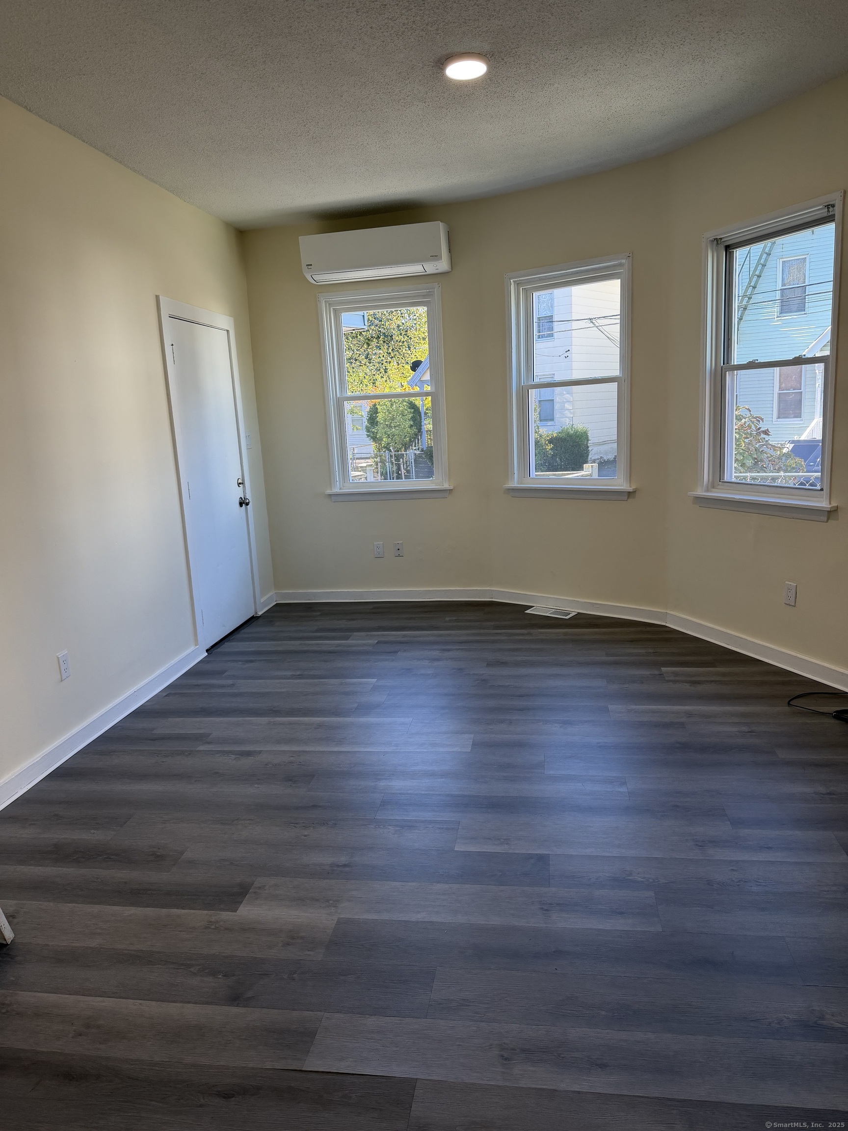 13 Lines Street New Haven, CT 06519 - Photo 5 of 12 a view of an empty room with wooden floor and a window