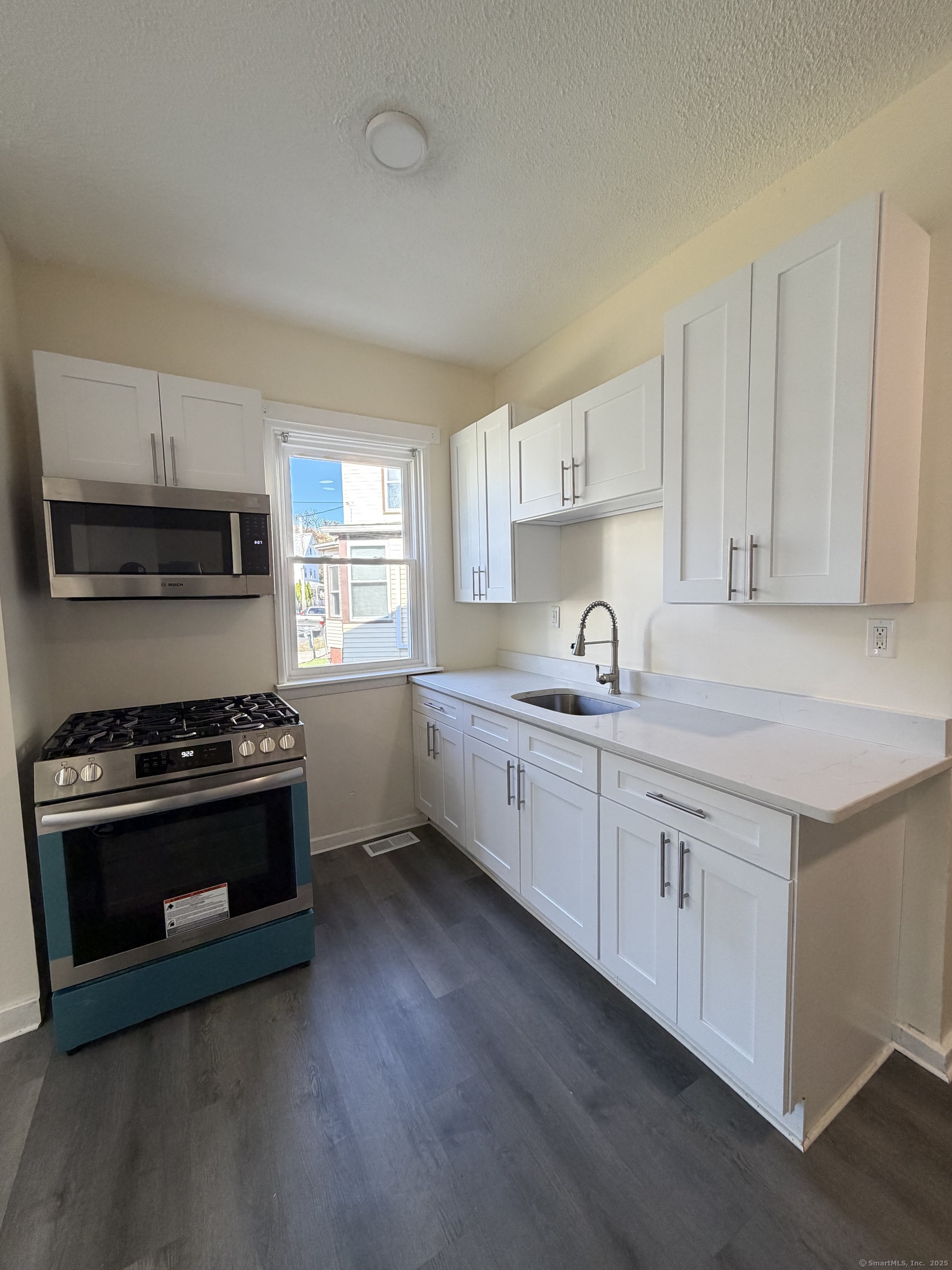 13 Lines Street New Haven, CT 06519 - Photo 6 of 12 a kitchen with sink stove and cabinets