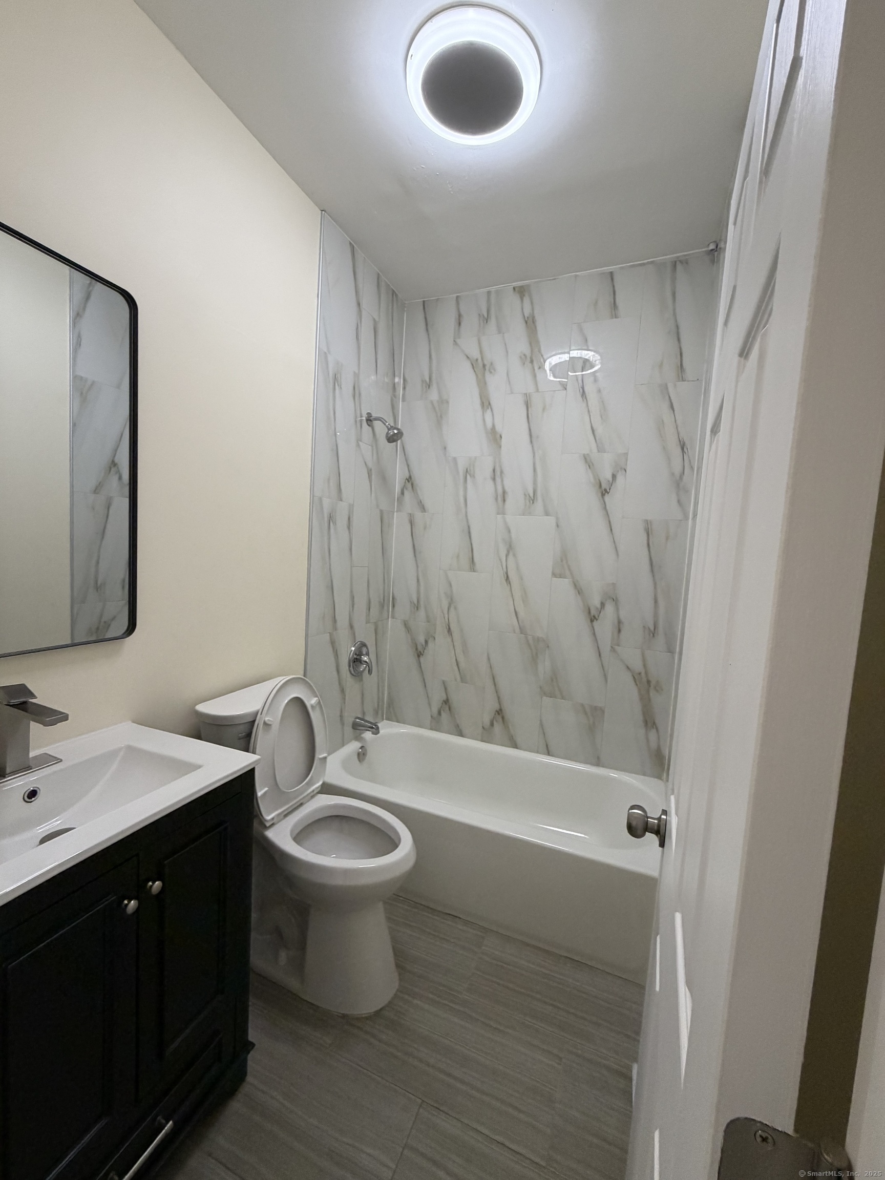 13 Lines Street New Haven, CT 06519 - Photo 8 of 12 a bathroom with a sink a toilet and shower