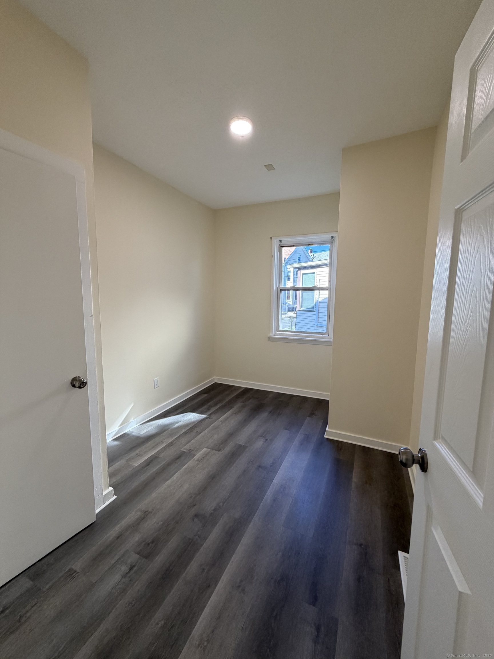 13 Lines Street New Haven, CT 06519 - Photo 9 of 12 an empty room with wooden floor and window