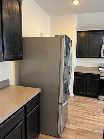 a kitchen with stainless steel appliances a refrigerator and a stove