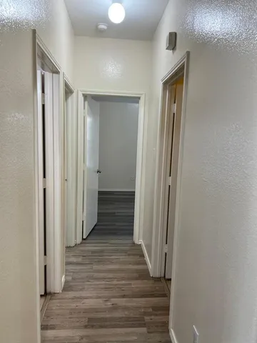a view of a hallway with a wooden floor