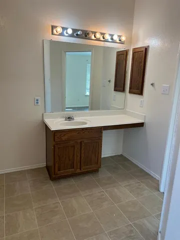 a bathroom with a sink a mirror and vanity