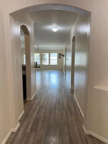 a view of gallery with wooden floor